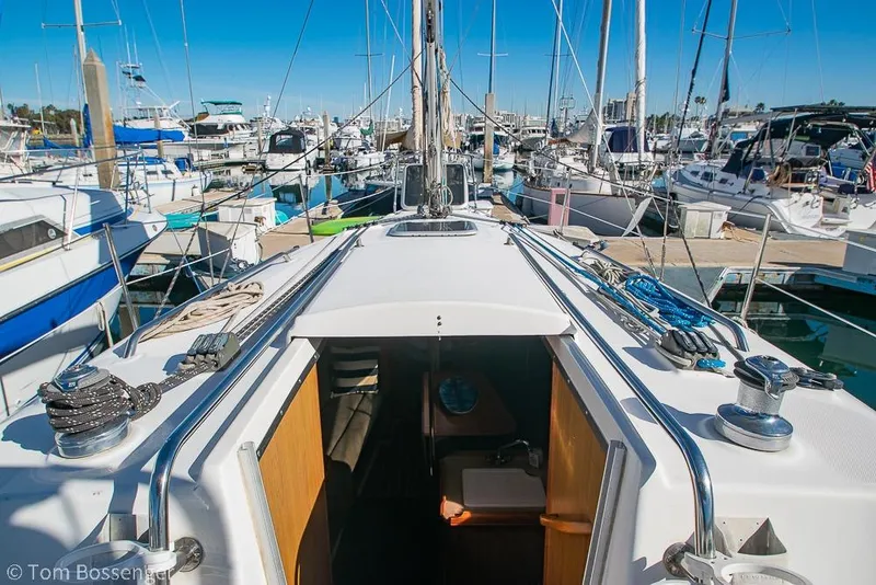 Slide: The Image of Hunter 31 sailboat from 2008 docked at a marina, surrounded by other boats. - 27
