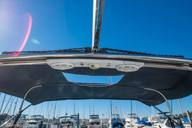 Slide: The Image of 2008 Hunter 31 sailboat cockpit view with blue sky and marina background. - 28