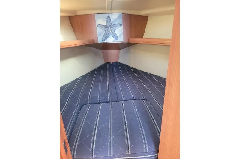 Slide: The Image of Cozy cabin interior of 2008 Hunter 31 sailboat with starfish decor. - 39