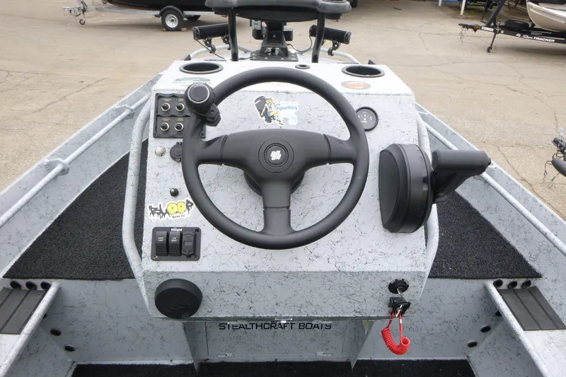 Slide: The Image of StealthCraft 16 StealthWeld 2025 boat dashboard with steering wheel and controls. - 10