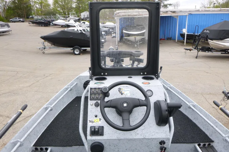 Slide: The Image of StealthCraft 16 StealthWeld 2025 boat dashboard with steering wheel and controls. - 11