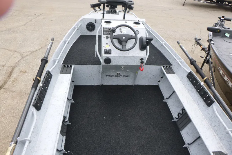 Slide: The Image of 2025 StealthCraft 16 StealthWeld boat interior with steering console and rod holders. - 4