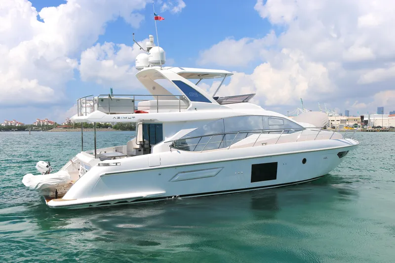 The Image of Luxury 2020 Azimut 55 yacht on calm waters under a partly cloudy sky. - 0