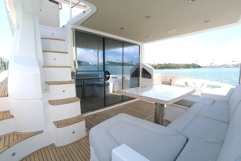 Slide: The Image of Luxurious 2020 Azimut 55 yacht deck with seating, table, and ocean view. - 16