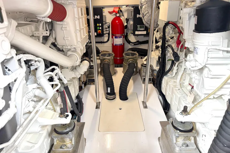 Slide: The Image of Engine room of 2020 Azimut 55 yacht, featuring mechanical components and fire extinguisher. - 23