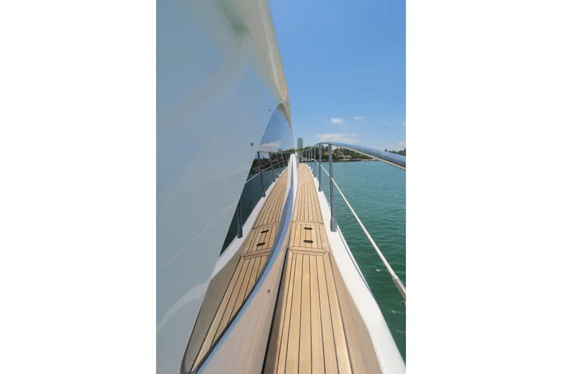 Slide: The Image of Side deck view of 2020 Azimut 55 yacht on calm water under clear sky. - 24