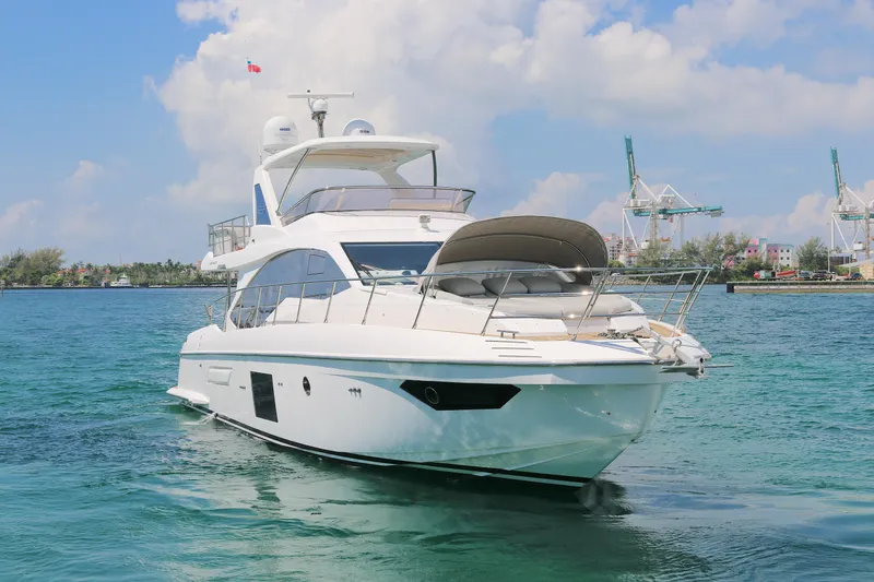 Slide: The Image of Luxury 2020 Azimut 55 yacht cruising in clear blue waters under a sunny sky. - 31