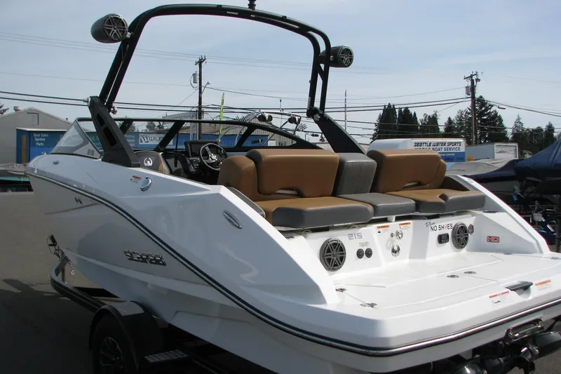 Slide: The Image of 2022 Scarab 215 ID boat with sleek design, brown seating, and modern audio system. - 1