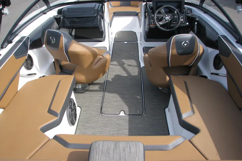 Slide: The Image of Interior of 2022 Scarab 215 ID boat with tan seating and modern dashboard. - 12