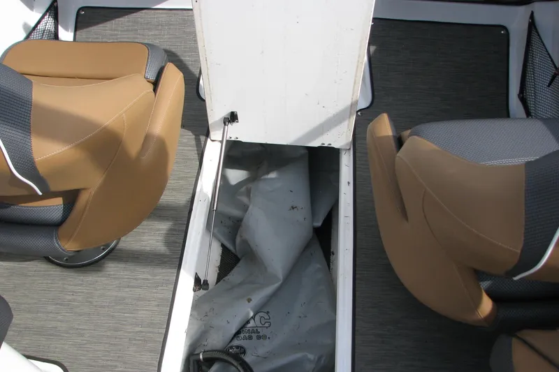 Slide: The Image of 2022 Scarab 215 ID boat interior with tan seats and storage compartment. - 13