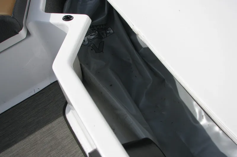 Slide: The Image of Storage compartment in a 2022 Scarab 215 ID boat, featuring sleek interior design. - 15