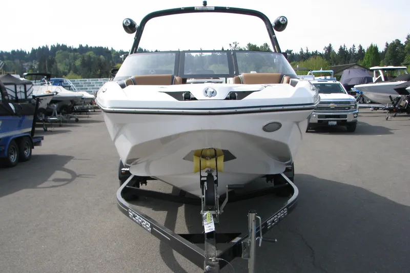 Slide: The Image of 2022 Scarab 215 ID boat on trailer, parked outdoors at a dealership. - 2
