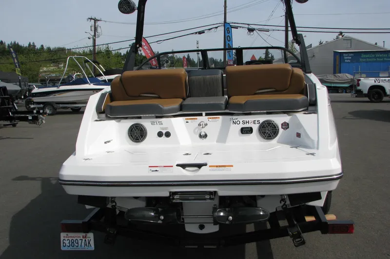 Slide: The Image of 2022 Scarab 215 ID boat rear view with seating and speakers at a dealership. - 3