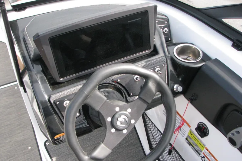 Slide: The Image of 2022 Scarab 215 ID boat dashboard with steering wheel and control panel. - 7