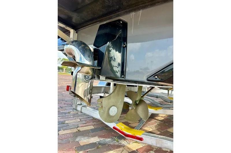 Slide: The Image of 2018 Nautique Super Air Nautique GS22 boat propeller and rudder detail on trailer. - 14
