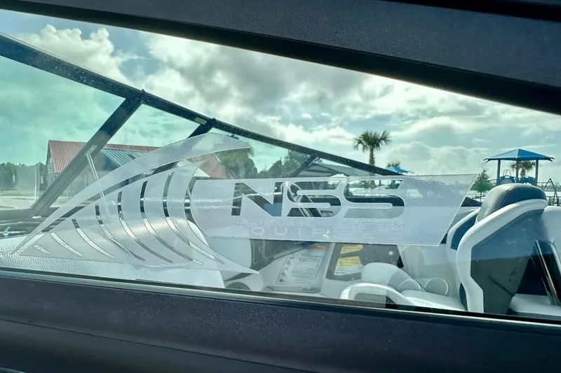 Slide: The Image of 2018 Nautique Super Air Nautique GS22 with NSS logo on window, sunny day background. - 16