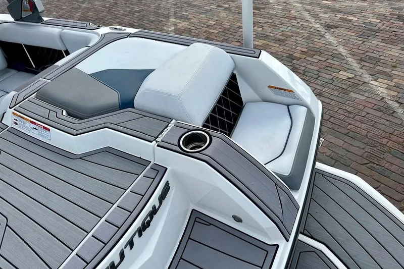 Slide: The Image of 2018 Nautique Super Air Nautique GS22 boat interior with cushioned seating and sleek design. - 18
