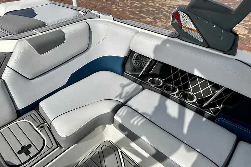 Slide: The Image of 2018 Nautique Super Air Nautique GS22 interior with cushioned seating and cup holders. - 27