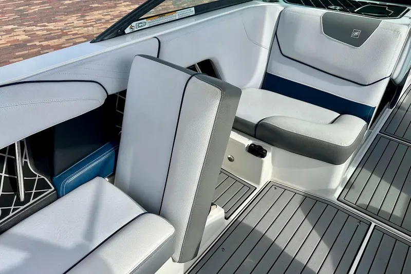 Slide: The Image of 2018 Nautique Super Air Nautique GS22 interior seating with gray and blue upholstery. - 31