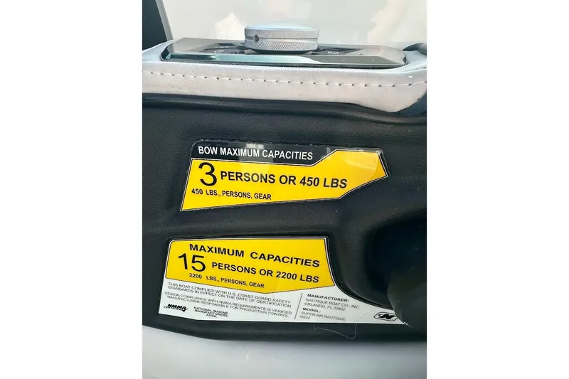 Slide: The Image of Capacity labels on 2018 Nautique Super Air Nautique GS22 boat, showing limits for passengers and weight. - 37