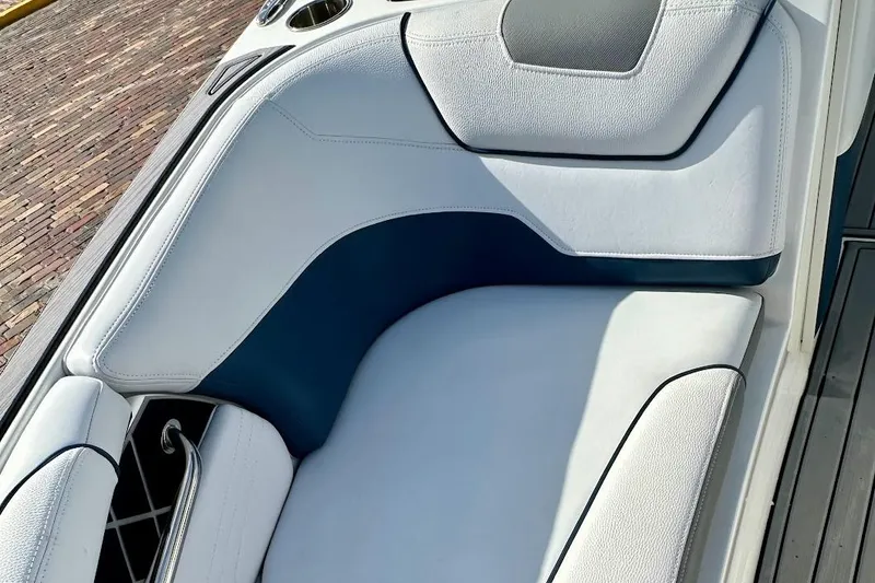 Slide: The Image of 2018 Nautique Super Air Nautique GS22 interior seating, featuring white and blue upholstery. - 41