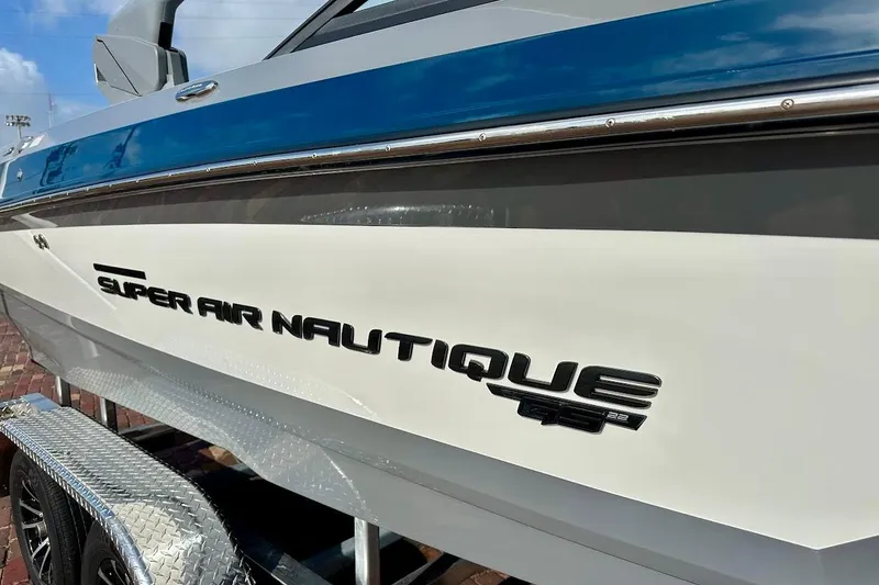 Slide: The Image of 2018 Nautique Super Air Nautique GS22 boat side view with logo detail. - 8