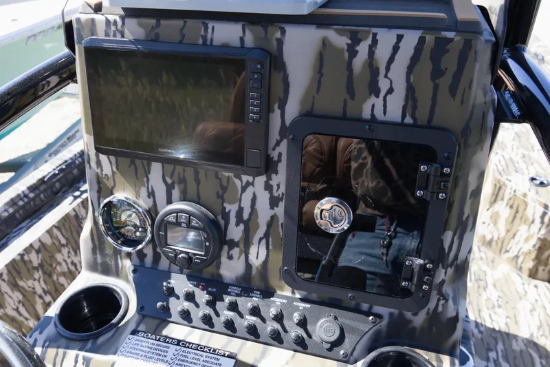 Slide: The Image of Control panel of 2026 Avid 22 Recon boat with camouflage design and electronic displays. - 11