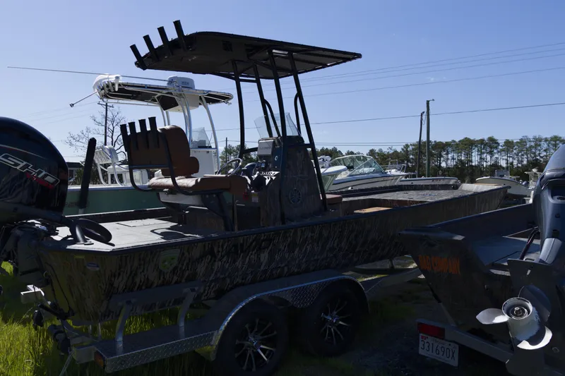 Slide: The Image of Avid 22 Recon 2026 boat on trailer, parked outdoors under clear sky. - 4