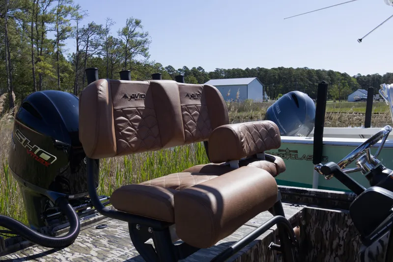 Slide: The Image of Avid 22 Recon boat interior with leather seats and dual outboard motors, 2026 model. - 9