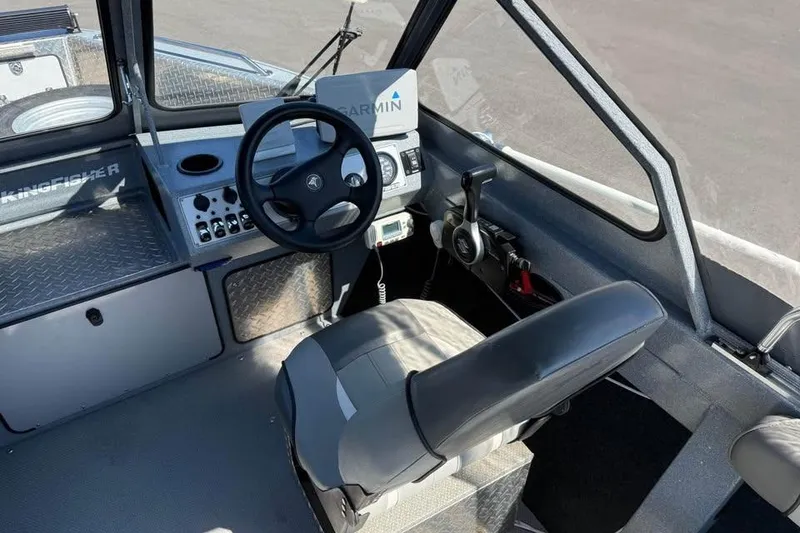 Slide: The Image of Interior of a 2021 KingFisher 1625 Falcon boat with steering wheel and Garmin navigation. - 10