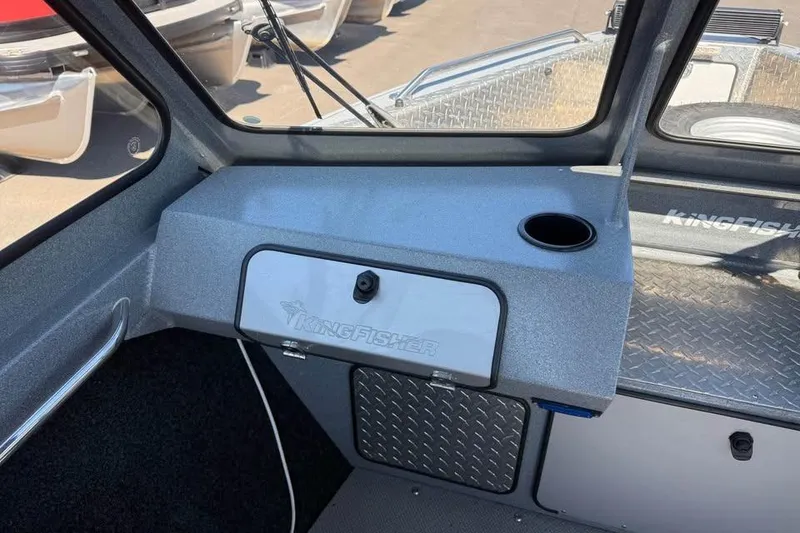 Slide: The Image of Interior of a 2021 KingFisher 1625 Falcon boat, featuring dashboard and cup holder. - 13