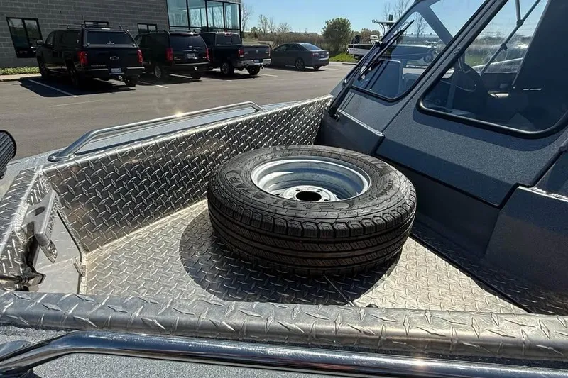 Slide: The Image of 2021 KingFisher 1625 Falcon boat with spare tire on diamond plate deck. - 16