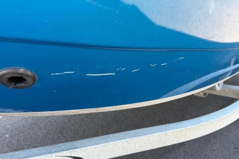 Slide: The Image of 2021 KingFisher 1625 Falcon boat with visible scratches on blue hull. - 18