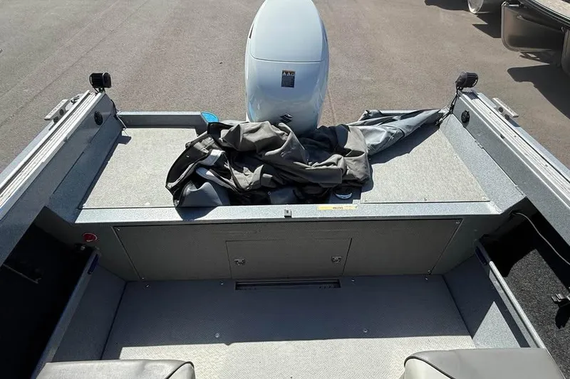 Slide: The Image of 2021 KingFisher 1625 Falcon boat interior with motor and storage area. - 6