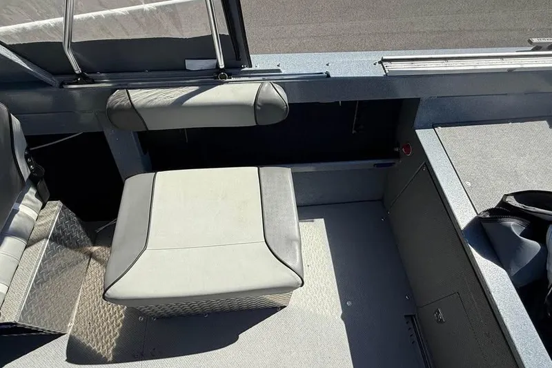 Slide: The Image of Interior of a 2021 KingFisher 1625 Falcon boat, featuring seating and storage compartments. - 8