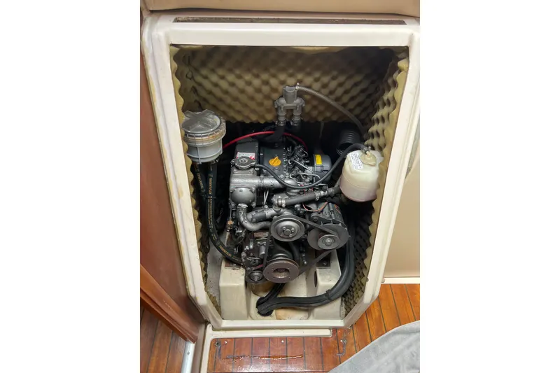 Slide: The Image of Engine compartment of a 1999 Beneteau Oceanis 321 sailboat, showcasing mechanical components. - 11