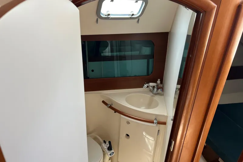 Slide: The Image of Interior view of 1999 Beneteau Oceanis 321 yacht bathroom with sink and toilet. - 23