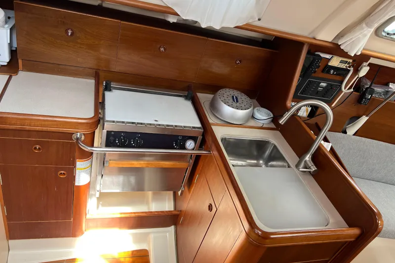 Slide: The Image of Interior view of 1999 Beneteau Oceanis 321 yacht kitchen with sink and stove. - 26