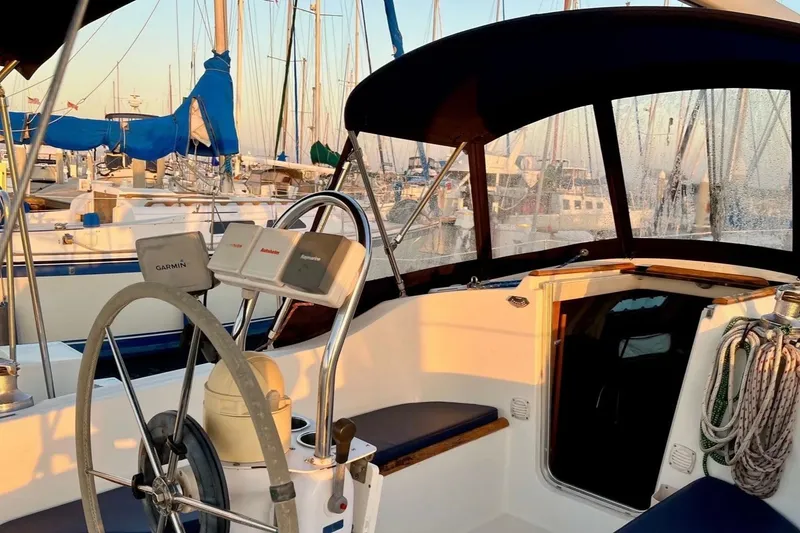 Slide: The Image of Cockpit of a 1999 Beneteau Oceanis 321 sailboat with marina view at sunset. - 4