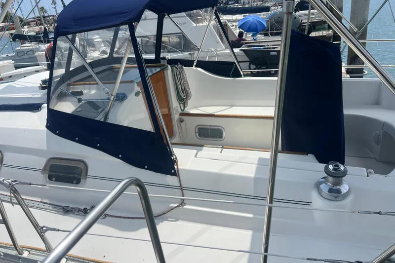 Slide: The Image of 1999 Beneteau Oceanis 321 sailboat cockpit with blue canopy, docked at marina. - 41