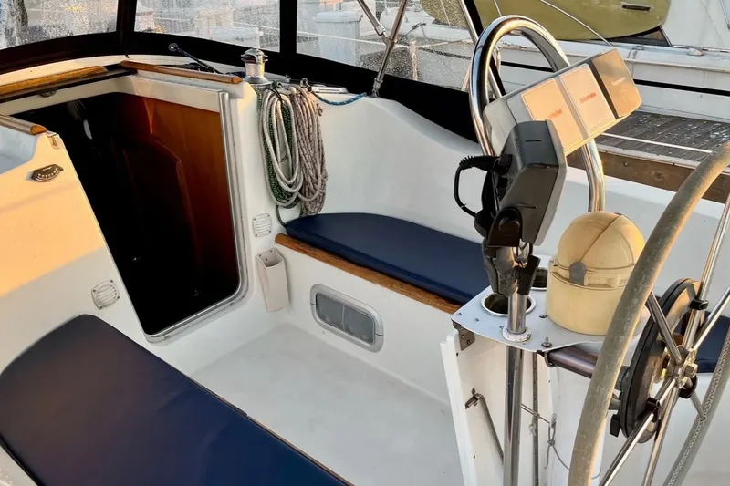 Slide: The Image of Cockpit of 1999 Beneteau Oceanis 321 sailboat with seating and steering wheel. - 5