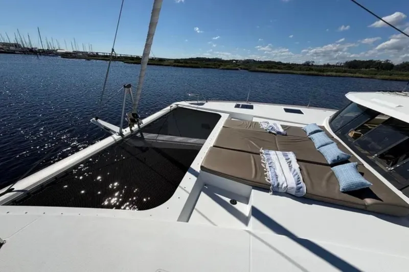 Slide: The Image of 2018 Fountaine Pajot Saona 47 catamaran with sunbathing area on calm water. - 10