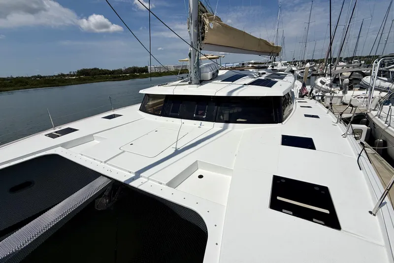 Slide: The Image of 2018 Fountaine Pajot Saona 47 catamaran docked, showcasing sleek design and spacious deck. - 11