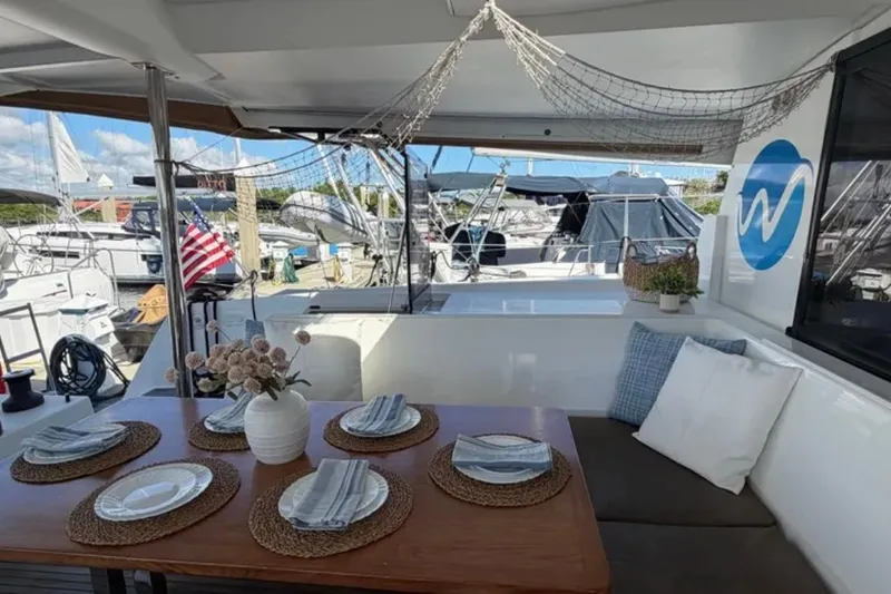 Slide: The Image of Outdoor dining area on 2018 Fountaine Pajot Saona 47 catamaran, docked with nautical decor. - 15
