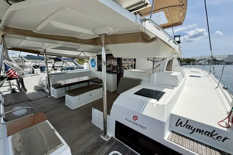 Slide: The Image of 2018 Fountaine Pajot Saona 47 catamaran with spacious deck and seating area. - 16