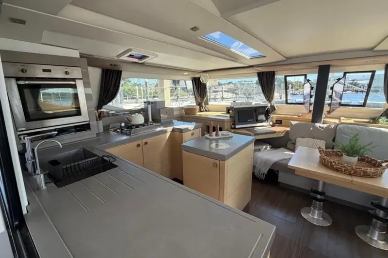 Slide: The Image of Luxurious interior of 2018 Fountaine Pajot Saona 47 catamaran with modern kitchen and seating area. - 21