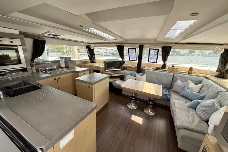 Slide: The Image of Luxurious interior of 2018 Fountaine Pajot Saona 47 catamaran with modern kitchen and cozy seating area. - 22