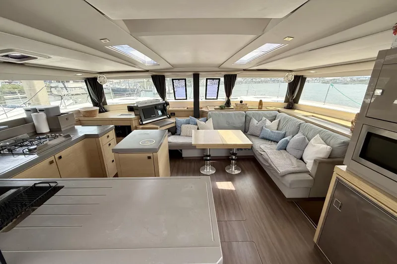 Slide: The Image of Luxurious interior of 2018 Fountaine Pajot Saona 47 catamaran with modern kitchen and seating area. - 23