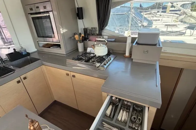 Slide: The Image of Modern kitchen interior on 2018 Fountaine Pajot Saona 47 catamaran, featuring sleek appliances and ample storage. - 25