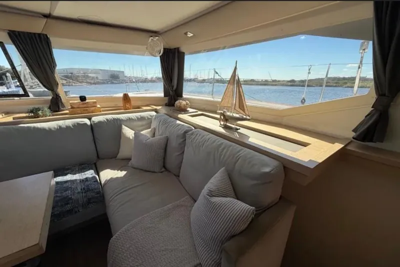 Slide: The Image of Interior of 2018 Fountaine Pajot Saona 47 yacht with cozy seating and scenic window view. - 31